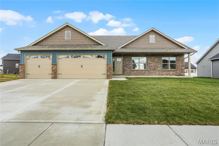 Craftsman-style home featuring a garage and a front yard
