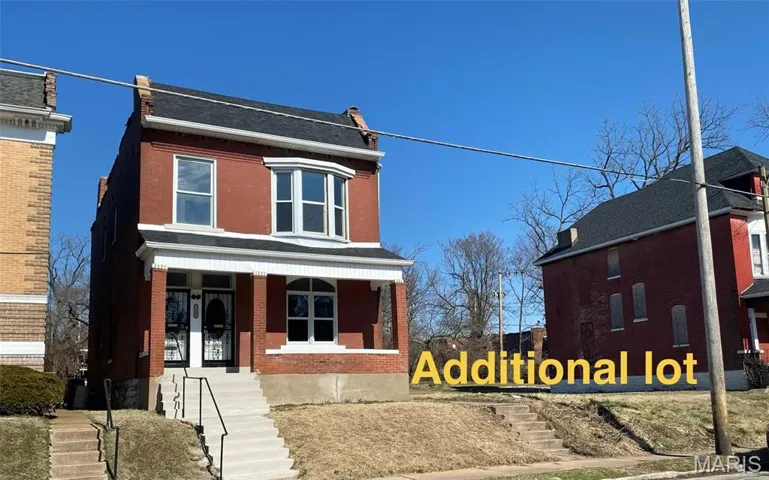 View of front of property featuring brick siding and covered porch