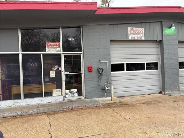 View of exterior entry featuring a garage