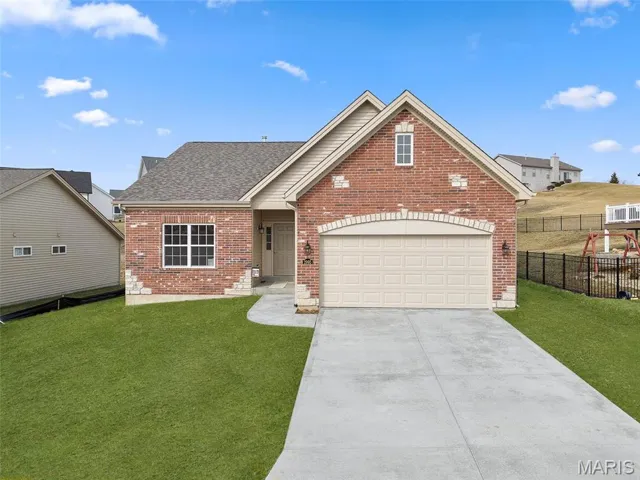 Brick Facade with Stone Accents, Garage Coach Lights, Architectural Shingles and Lawn Irrigation
