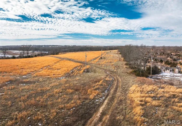 Birds eye view of property with a rural view