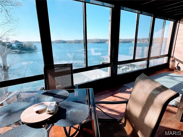 Sunroom / solarium with a water view