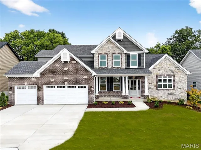 View of front of property with a shingled roof, a porch, concrete driveway, and a garage