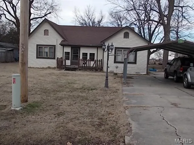 View of front of property with a carport