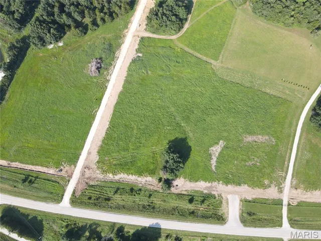 Aerial view of property and surrounding area featuring property boundaries highlighted