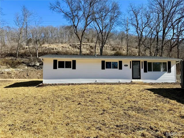 Single story home featuring a front yard