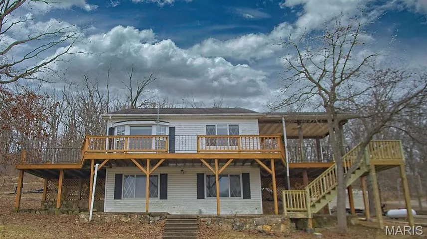 Back of house featuring a deck and stairway