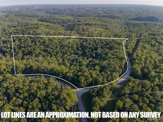 Aerial view of property and surrounding area with property parcel outlined