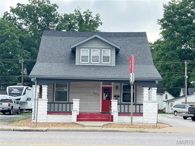Bungalow with a porch, a chimney, and a shingled roof