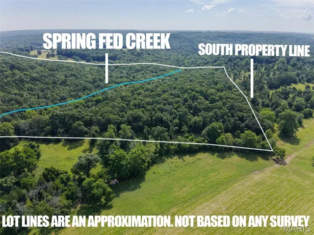 Aerial view of property and surrounding area with property boundaries highlighted and a forest