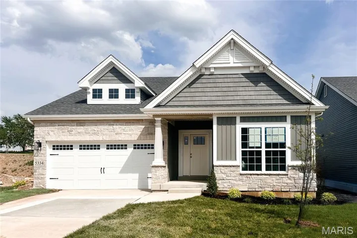 Craftsman inspired home with stone siding, concrete driveway, a shingled roof, a front yard, and an attached garage