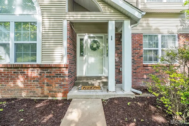 Entrance to property with brick siding