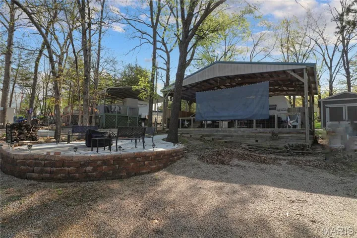 View of yard featuring a patio, a fire pit, and a carport