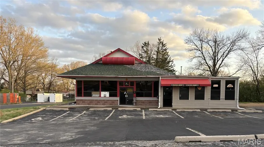 View of property featuring uncovered parking