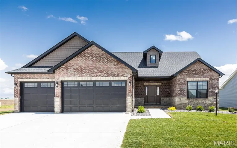 View of front facade featuring a garage, concrete driveway, a front yard, roof with shingles, and stone siding
