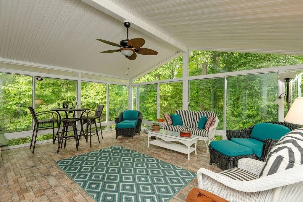 Bright sunroom with tiled flooring overlook back yard Bright sunroom with tiled flooring overlook back yard