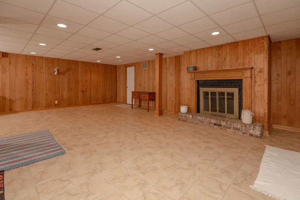 Basement is paneled with tiled flooring Basement is paneled with tiled flooring
