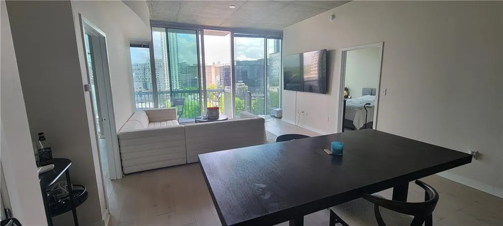 Dining room featuring light wood-style flooring, floor to ceiling windows, and baseboards