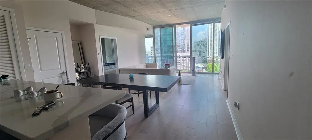 Dining area featuring light wood finished floors and floor to ceiling windows