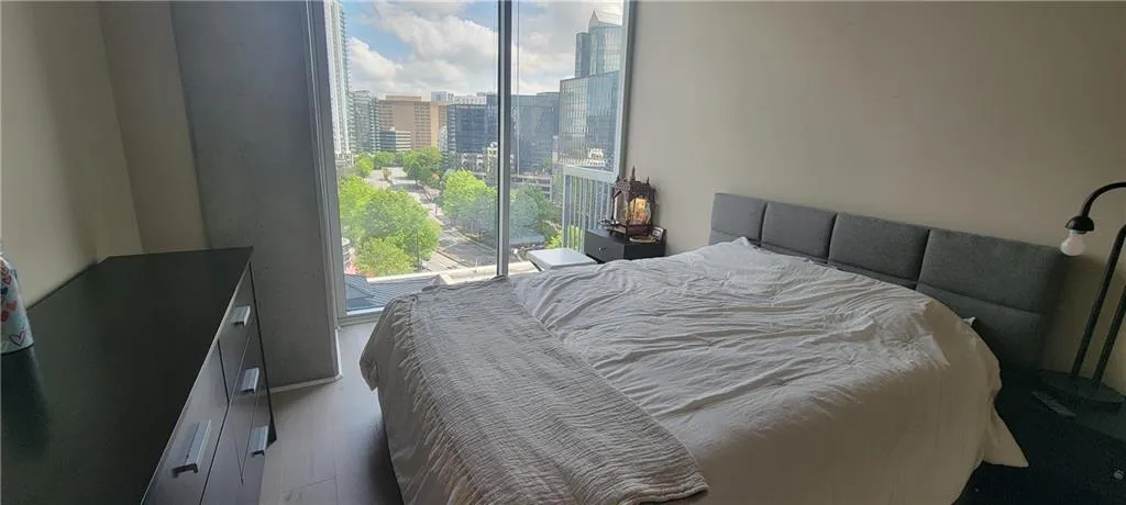 Bedroom featuring wood finished floors and a city view