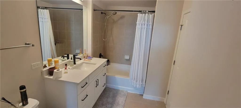 Full bathroom featuring shower / tub combo, tile patterned floors, and vanity