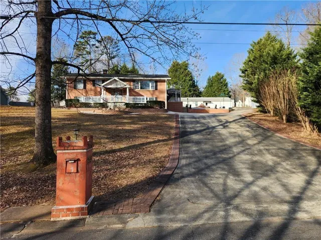 Brick exterior residence with a covered porch and white columns