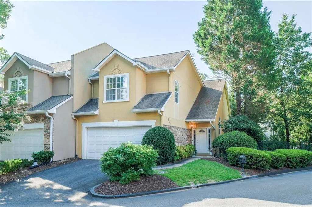 Lovely end unit with 2 car garage and driveway parking for two more cars.