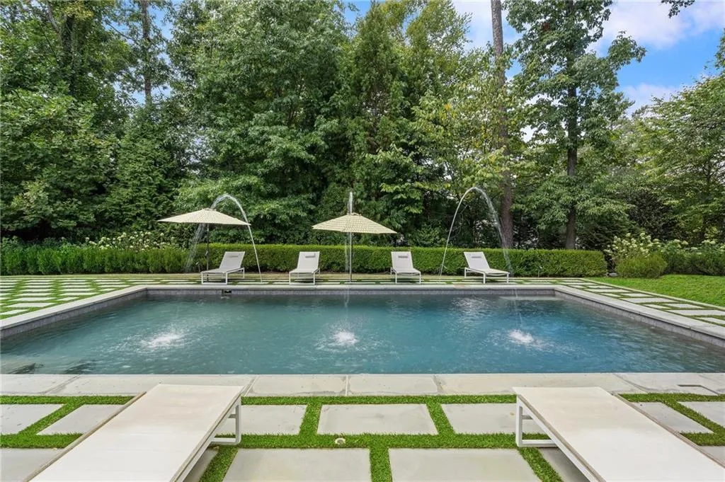 Iron doors open to firepit and pool. Fireplace in media room.