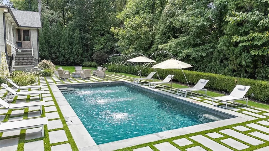 Newer pool with bluestone pavers, fountains and turf.