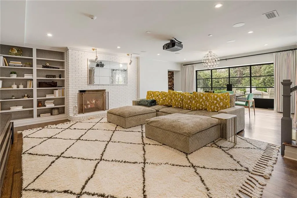 Retractable Iron doors open to firepit and pool. Fireplace in media room.