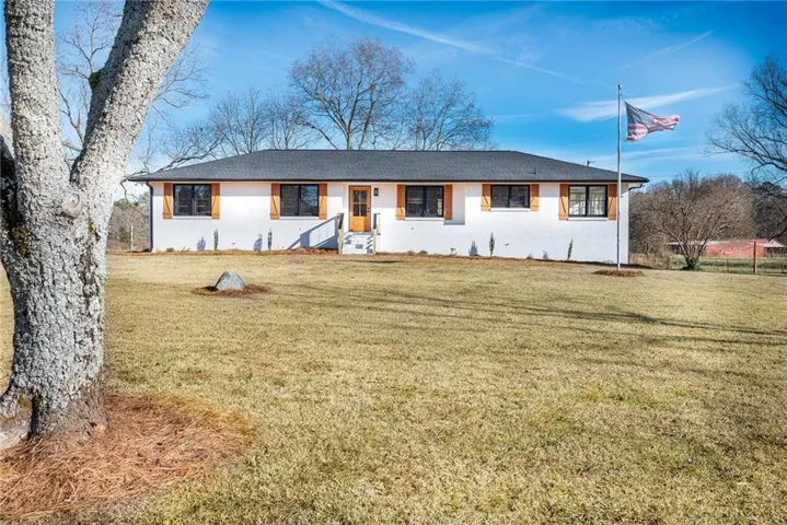 Ranch-style house with a front lawn
