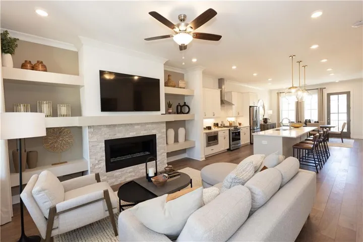 The family has a cozy fireplace. Not actual home. Photos of model home Cochran floorplan.