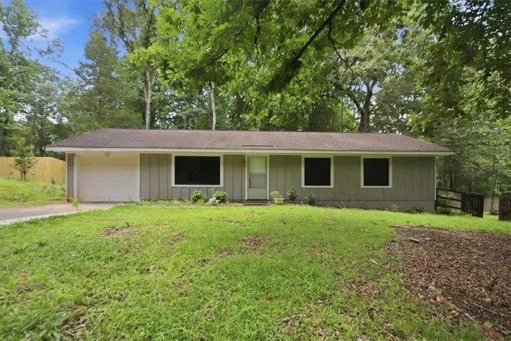 Ranch-style exterior with a neutral siding finish, a single-car garage, and a brown shingle roof