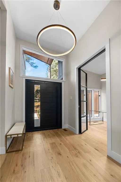 Foyer entrance featuring light wood-style floors and baseboards