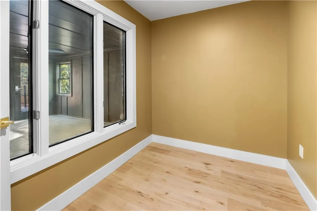 Spare room with baseboards and light wood finished floors