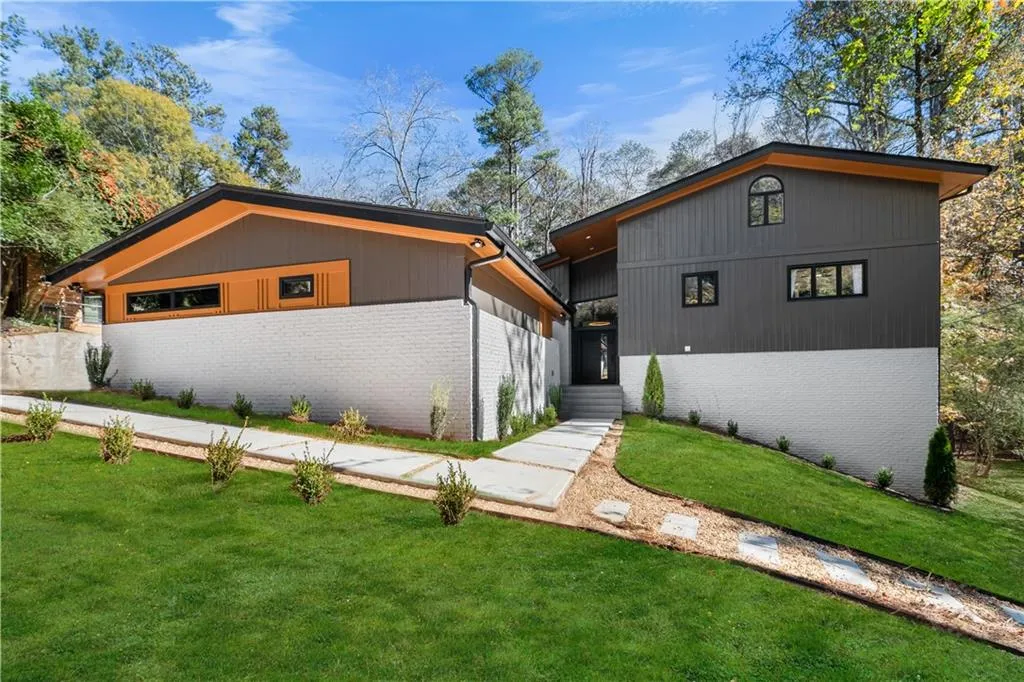 View of front of house with brick siding and a front yard