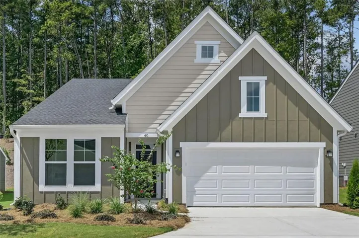 Contemporary craftsman-style residence featuring a dark gray vertical siding gable with white trim