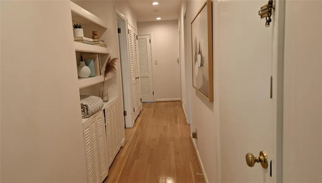 Hallway with built-in bookshelves and linen closet (2 bedrooms are off center of hall, 2 bedrooms are off end of hall)