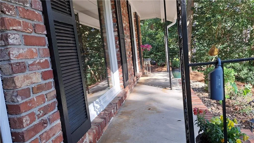 Plenty of room to enjoy sitting on front porch, which extends all the way across the front of this custom-built home