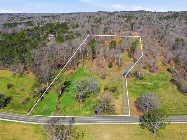 View of property location with property boundaries highlighted and a forest