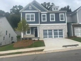 Two-story exterior with blue siding and stone veneer