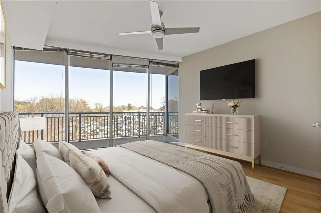 Bedroom featuring access to outside, light wood-style floors, and ceiling fan