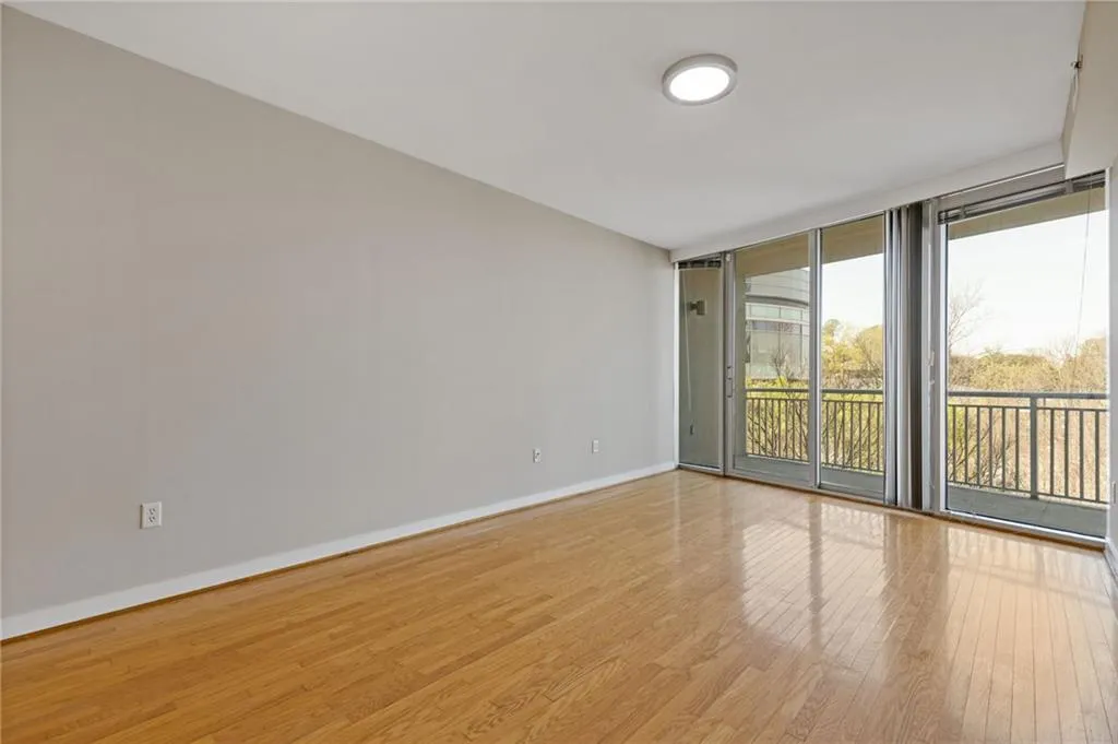 Empty room with wood finished floors and expansive windows