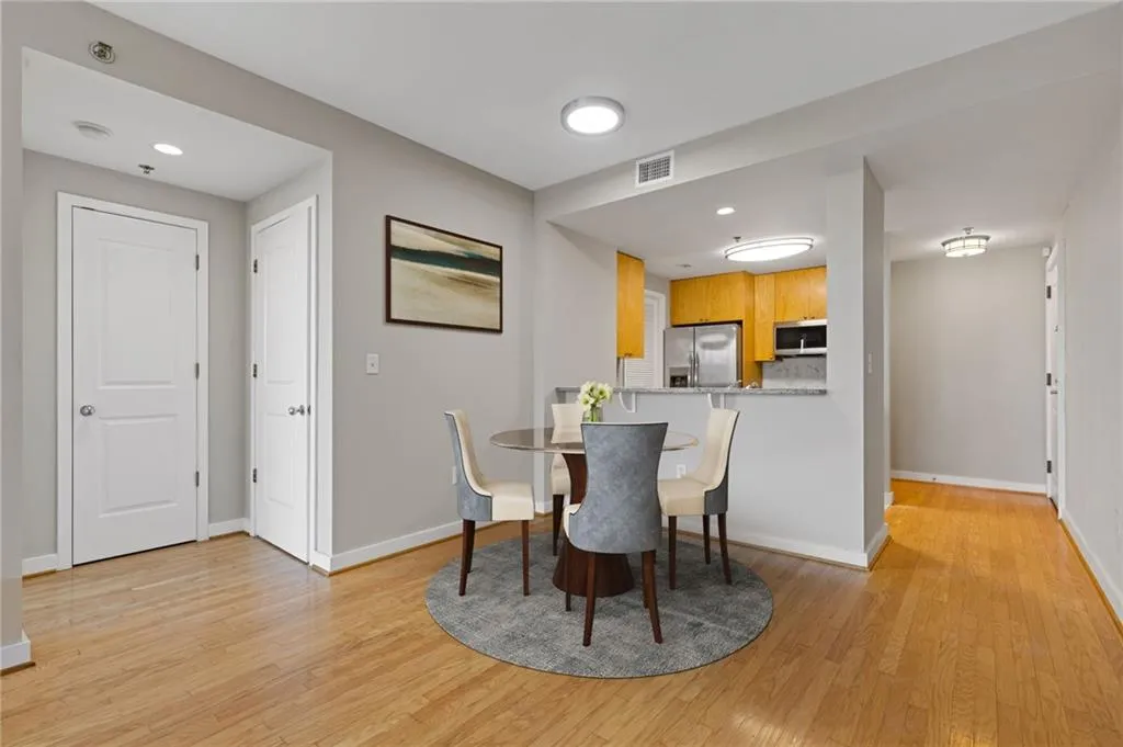 Dining room with light wood-type flooring and recessed lighting
