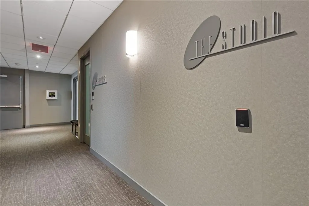 Hall featuring carpet flooring, recessed lighting, and a drop ceiling