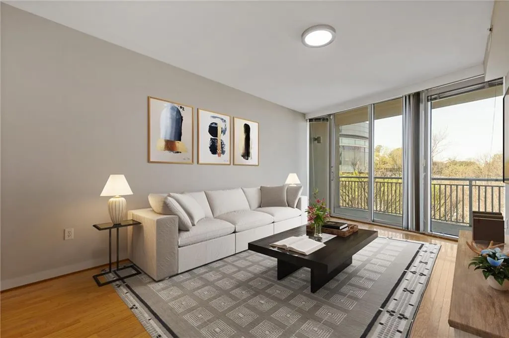 Living room featuring light wood-style flooring and expansive windows