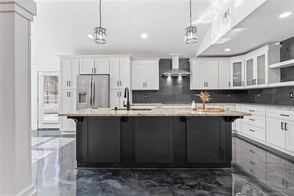 Kitchen with a kitchen bar, glass insert cabinets, white cabinetry, stainless steel fridge with ice dispenser, and recessed lighting