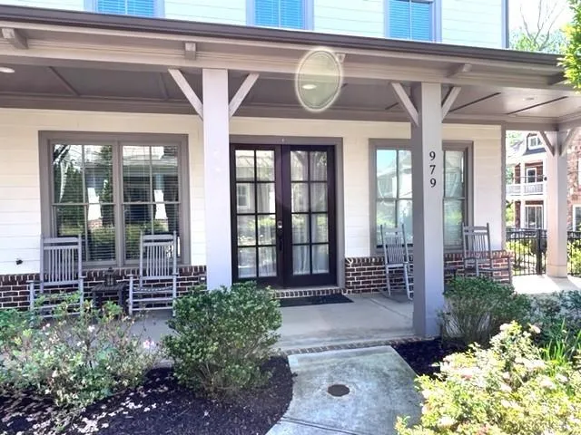 View of exterior entry featuring covered porch