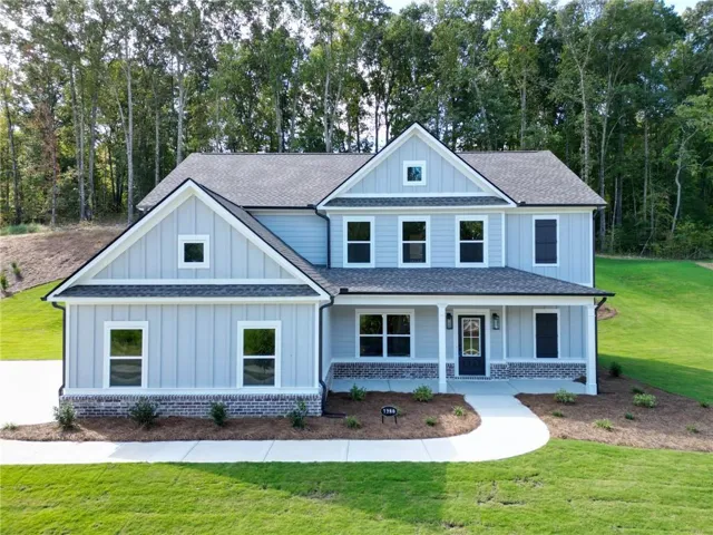 Transitional style exterior featuring light blue siding, white trim, and a covered porch
