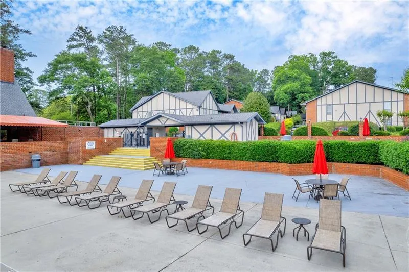 Pool Deck/Lounge area with multiple tables and outdoor umbrellas